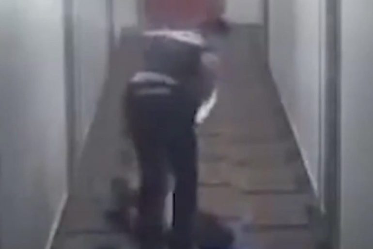 A police officer drags a woman in a panic attack and presses her on the head