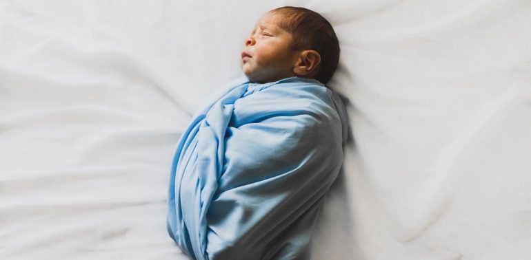 photo of new born baby covered with blue blanket 3617844