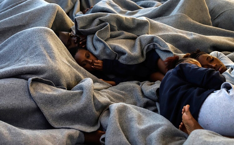 Immigrants under blankets