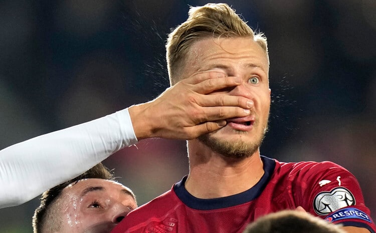 A hand in a soccer player's eye