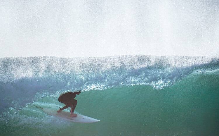 Surfer under the wave