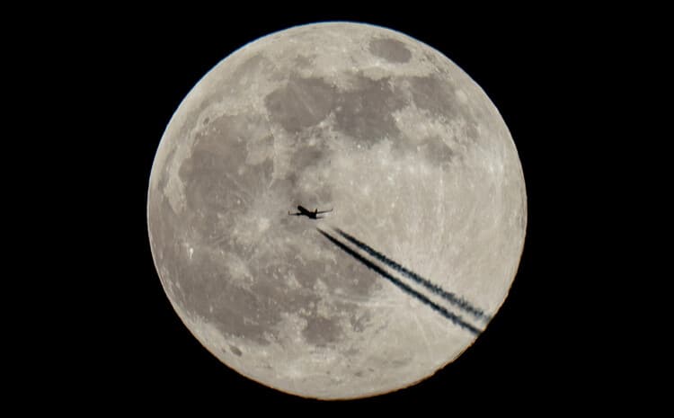 Full moon and plane