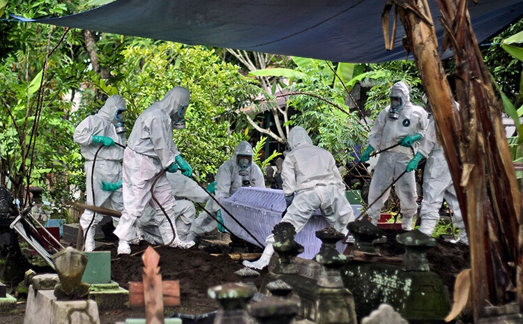 Мужчины на ковидном кладбище в Индонезии