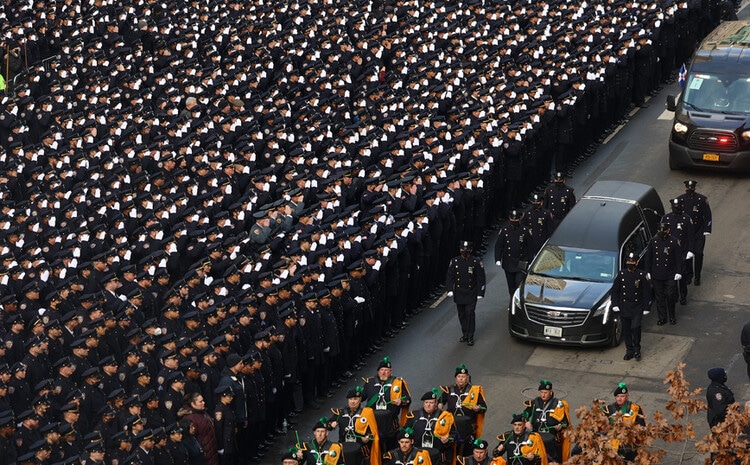 Police officers pay tribute to their colleagues who were killed