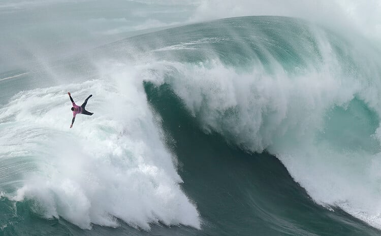 Surfer flies over a wave