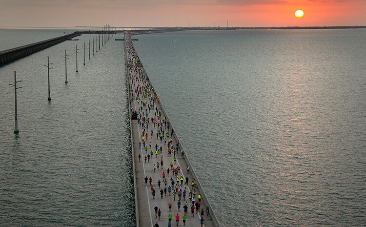 Runners run on a huge bridge