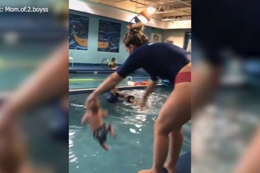 Damn video on TikTok showing an instructor throwing a baby in a pool